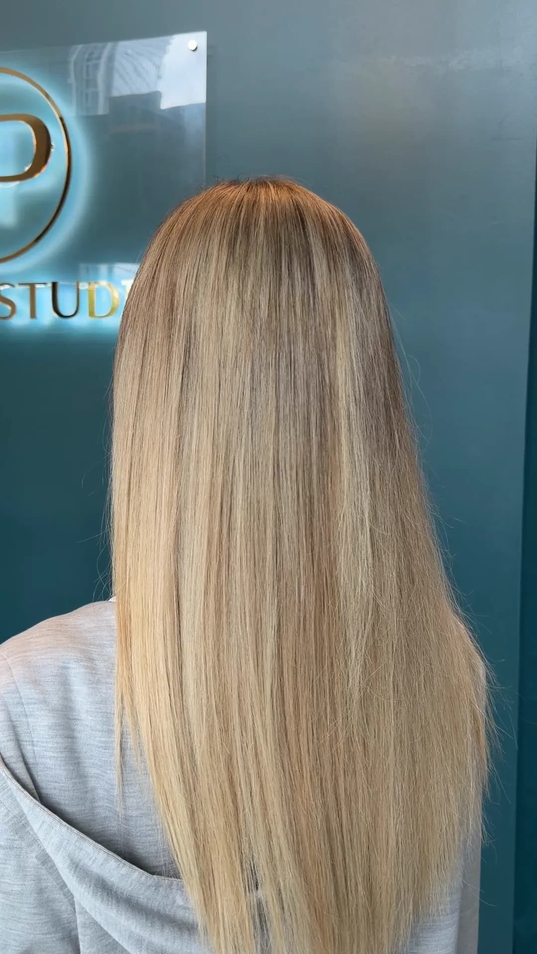 Long, straight blonde hair with a seamless blend from root to ends