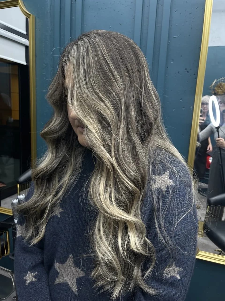 Brunette hair with bright blonde ribbons, styled in loose waves
