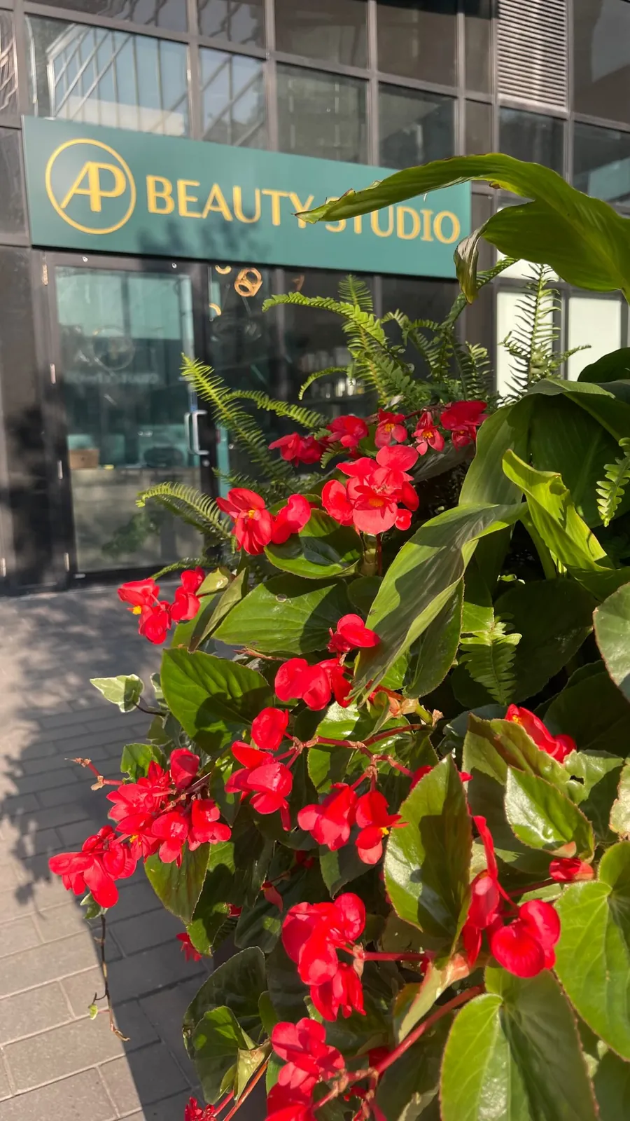 The AP Beauty Studio entrance on Highway 7 in Vaughan, with flowers by the door