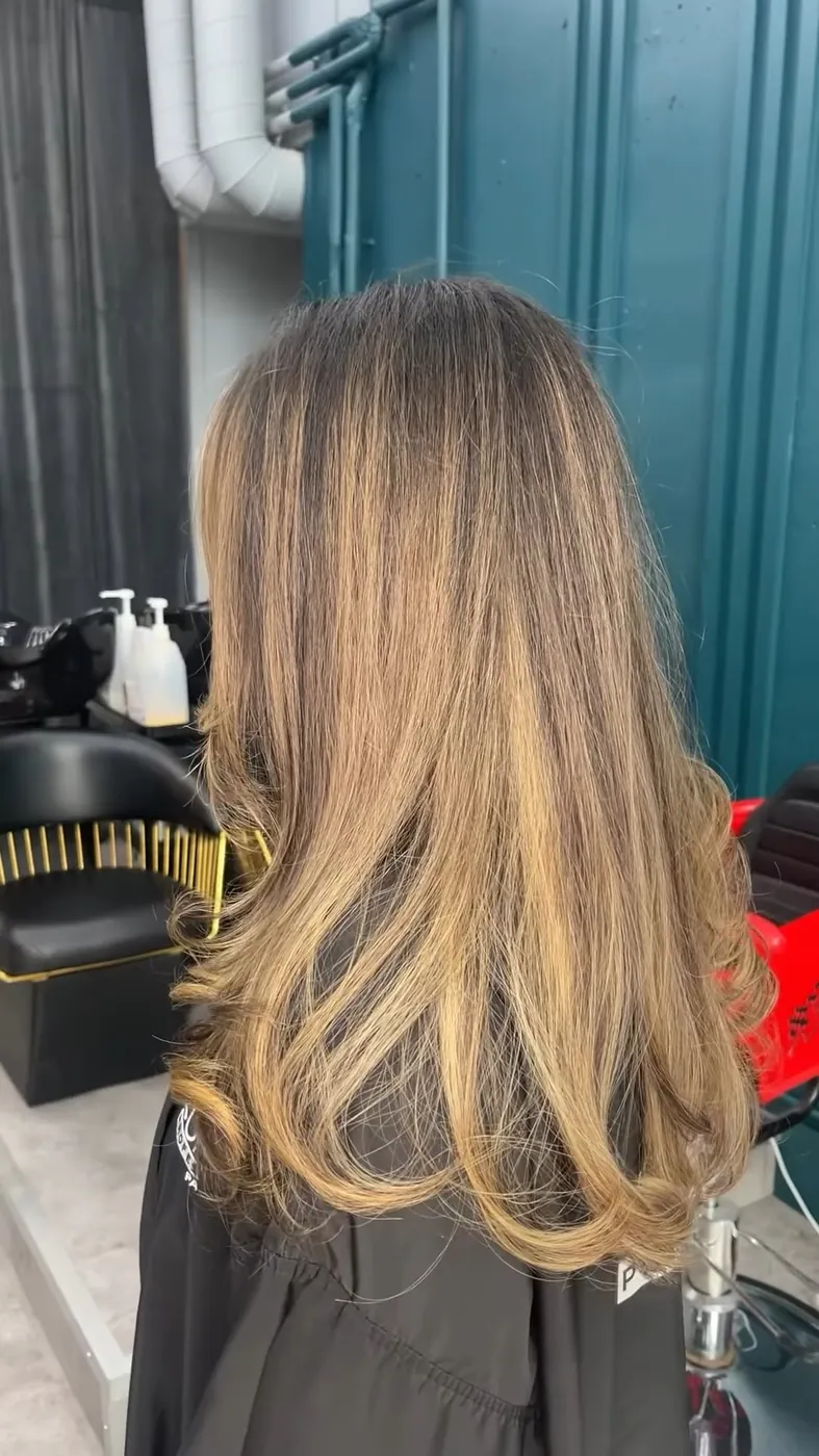 After: a soft, blended chocolate and honey balayage on the same client